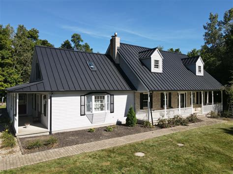 white brick house with metal roof|white house black metal roof.